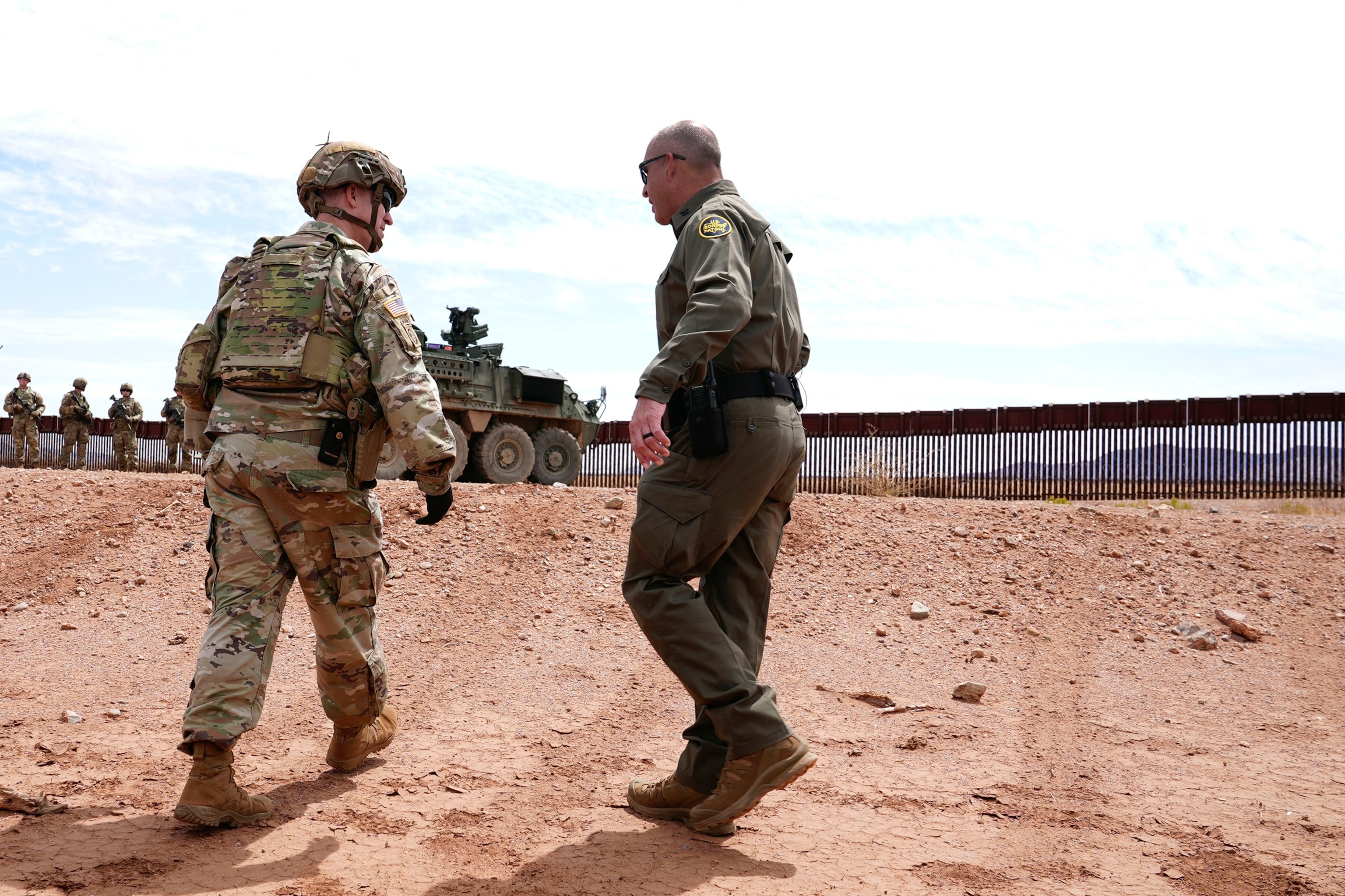 PHOTO: U.S. Army Lt. Col. Travis Stellfox, left, battalion commander of the 212 Infantry, talks with Michael Layton, acting patrol agent in charge of the U.S. Border Patrol Douglas Station, April 3, 2025, in Douglas, Ariz.