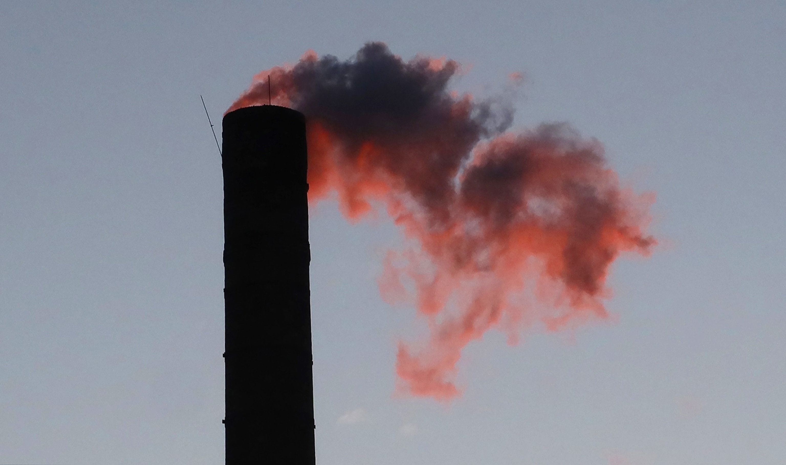 PHOTO: An emission comes out of a smoke stack on a building as the sun rises, Feb. 18, 2025,  in Hoboken, N.J.